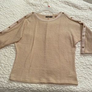 Doe and Rae brand cream colored sweater.